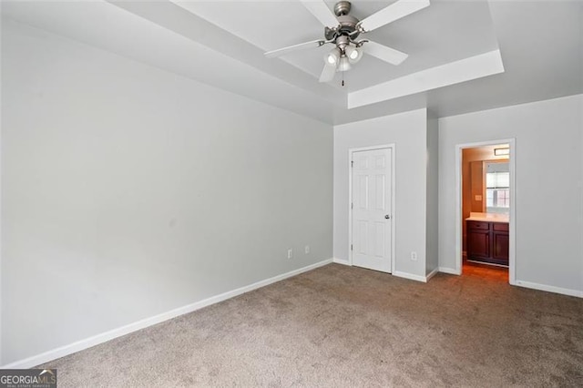 unfurnished bedroom featuring ensuite bath, carpet, and baseboards