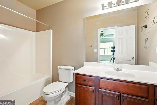 bathroom with toilet, tile patterned flooring, vanity, and shower / bath combination