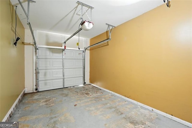 garage featuring baseboards and a garage door opener