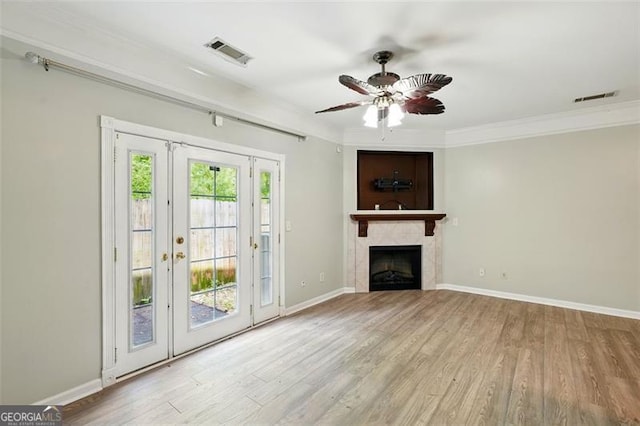 unfurnished living room featuring baseboards, a ceiling fan, visible vents, and wood finished floors