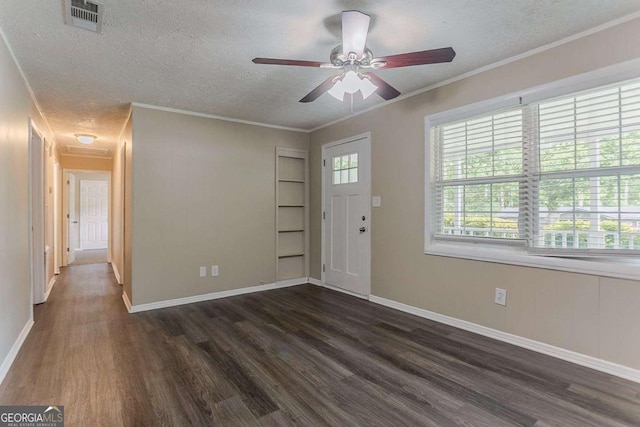foyer with a ceiling fan, a textured ceiling, dark wood-type flooring, and visible vents