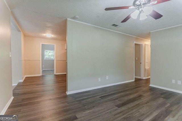 spare room with ceiling fan, a textured ceiling, and dark wood finished floors