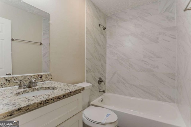 bathroom featuring bathing tub / shower combination, toilet, a textured ceiling, and vanity