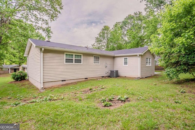 back of house with a yard, cooling unit, and crawl space