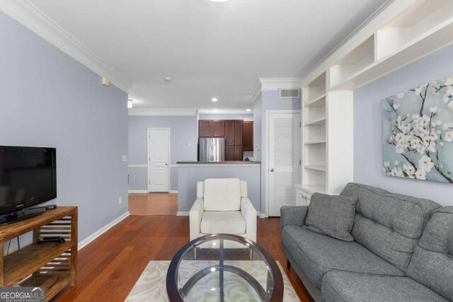 living room with crown molding, dark wood finished floors, baseboards, and recessed lighting