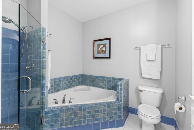 bathroom with a shower stall, toilet, a bath, and tile patterned floors