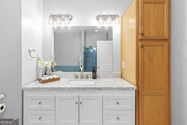 bathroom with a shower stall and vanity