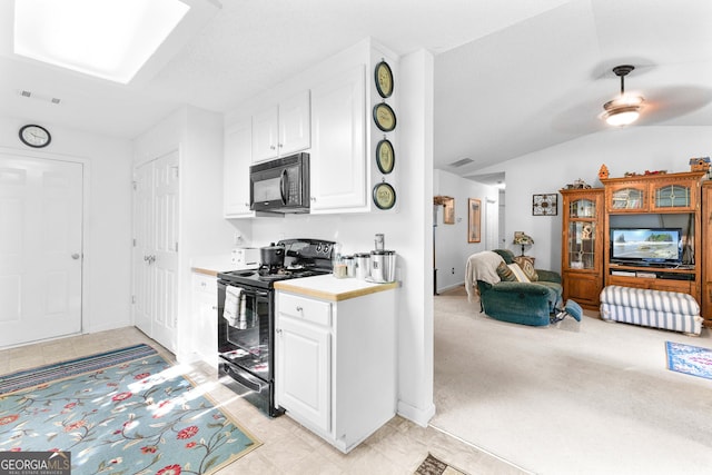 425 W Ridgeway Rd, Maysville, GA 30558 - kitchen featuring black appliances, vaulted ceiling, light countertops, white cabinetry, and open floor plan