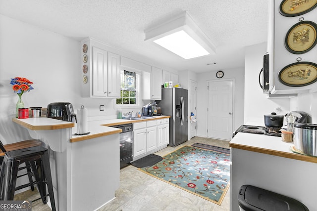 425 W Ridgeway Rd, Maysville, GA 30558 - kitchen featuring stainless steel refrigerator with ice dispenser, black dishwasher, white cabinets, a sink, and a breakfast bar area
