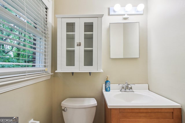 half bathroom with toilet and vanity