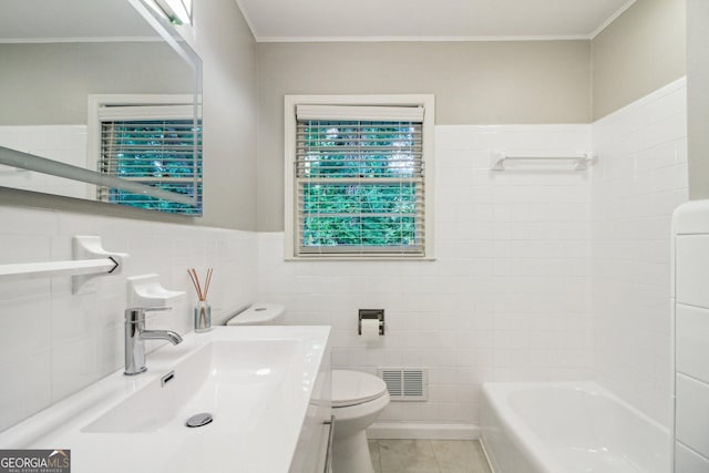 bathroom with toilet, tile walls, crown molding, and visible vents