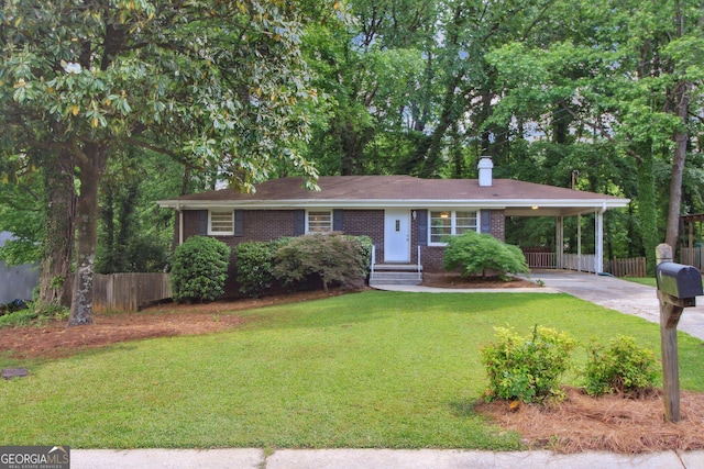 single story home with fence, brick siding, driveway, a front yard, and a carport