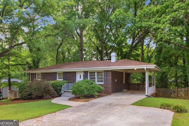 single story home featuring fence, brick siding, concrete driveway, a front lawn, and a chimney