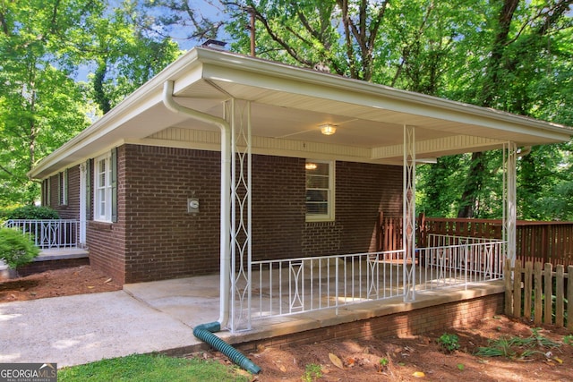view of side of home with a patio and brick siding