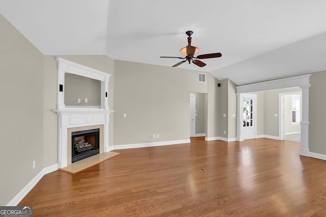 308 Jessica Way, Canton, GA 30114 - unfurnished living room with ceiling fan, vaulted ceiling, a fireplace with raised hearth, wood finished floors, and baseboards