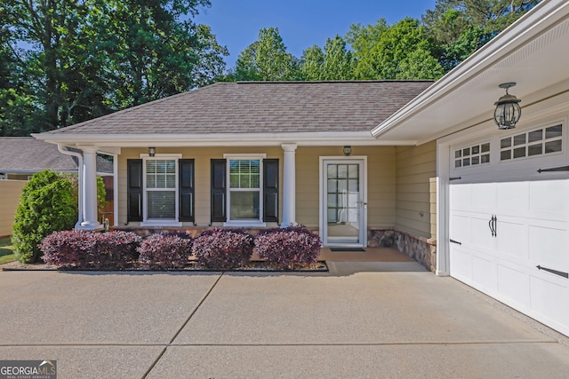 308 Jessica Way, Canton, GA 30114 - view of exterior entry with an attached garage, roof with shingles, covered porch, driveway, and stone siding