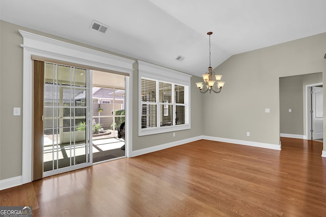 308 Jessica Way, Canton, GA 30114 - unfurnished dining area with a chandelier, wood finished floors, baseboards, and vaulted ceiling