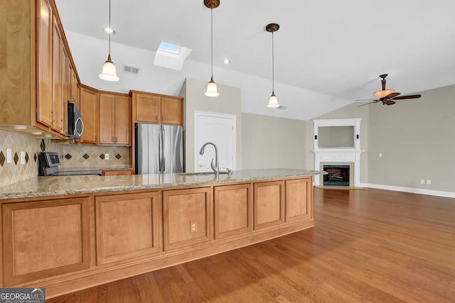 308 Jessica Way, Canton, GA 30114 - kitchen with stainless steel appliances, vaulted ceiling, backsplash, a skylight, and a ceiling fan