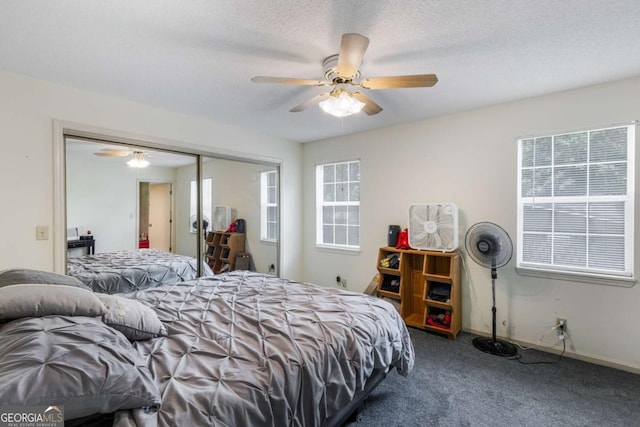 40 Carole Dr, Carrollton, GA 30117 - carpeted bedroom with a closet, a ceiling fan, and multiple windows