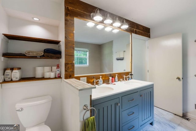 40 Carole Dr, Carrollton, GA 30117 - full bath featuring double vanity, toilet, visible vents, and a sink