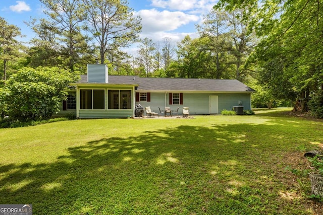 40 Carole Dr, Carrollton, GA 30117 - rear view of property with central AC, a sunroom, a chimney, a yard, and a patio area