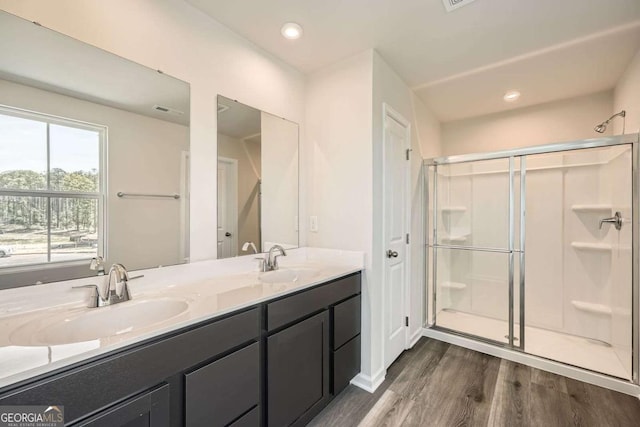 8491 Limerick Ln, Winston, GA 30187 - bathroom with a sink, a stall shower, and wood finished floors