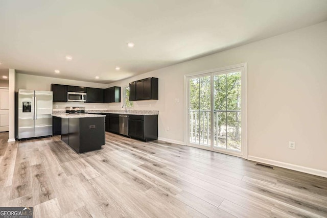8491 Limerick Ln, Winston, GA 30187 - kitchen featuring appliances with stainless steel finishes, visible vents, light countertops, baseboards, and light wood-style floors