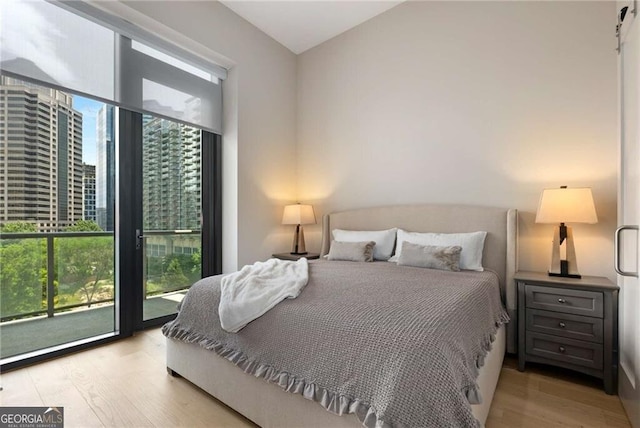 40 12th St NE Unit 803, Atlanta, GA 30309 - bedroom with a city view and light wood-style floors