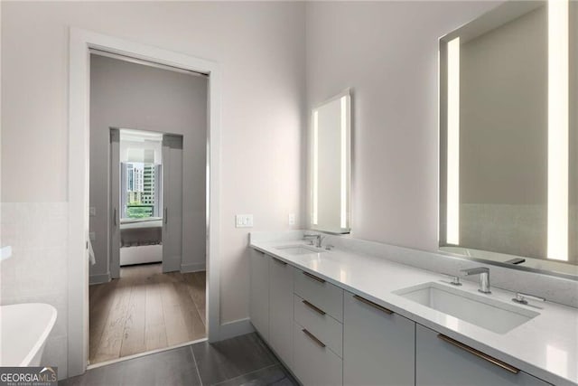 40 12th St NE Unit 803, Atlanta, GA 30309 - full bathroom with a sink, a soaking tub, double vanity, and tile patterned floors
