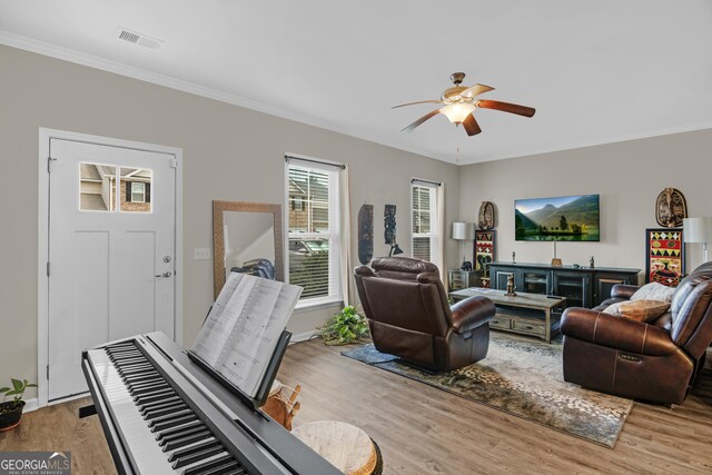 47 Reese Way, Savannah, GA 31419 - living room with crown molding, light wood-type flooring, visible vents, baseboards, and ceiling fan