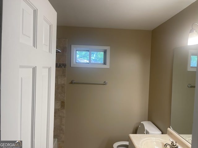 bathroom with toilet, a shower, vanity, and a tub to relax in