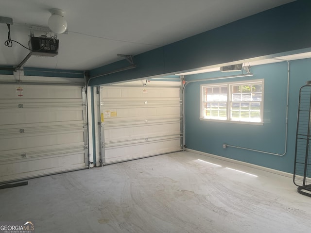 garage featuring a garage door opener and baseboards