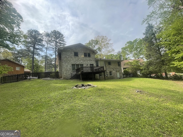 back of property with a deck and stone siding
