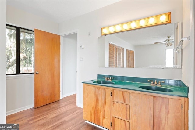 863 Hickory Bluff Rd, Waverly, GA 31565 - full bathroom with double vanity, wood finished floors, baseboards, and a sink