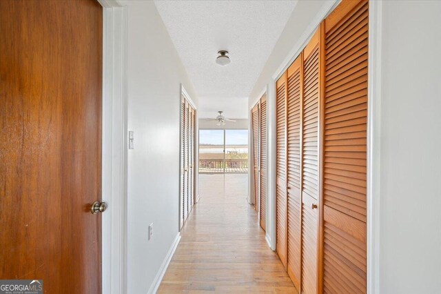 863 Hickory Bluff Rd, Waverly, GA 31565 - corridor with light wood-style floors, baseboards, and a textured ceiling