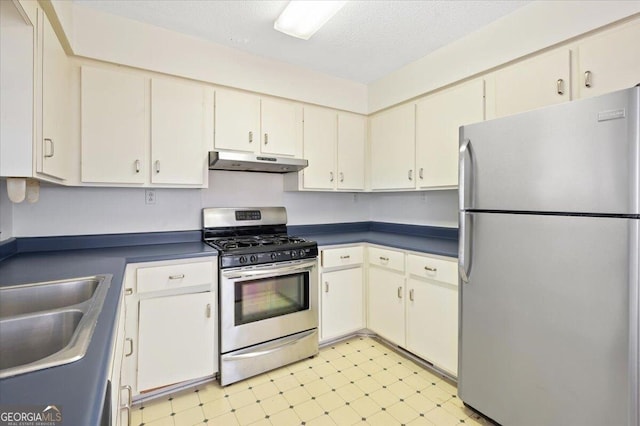 863 Hickory Bluff Rd, Waverly, GA 31565 - kitchen with a sink, light floors, under cabinet range hood, dark countertops, and appliances with stainless steel finishes