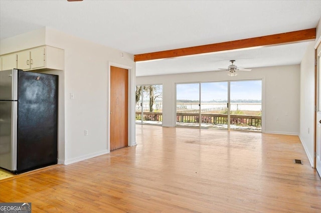 863 Hickory Bluff Rd, Waverly, GA 31565 - unfurnished living room with baseboards, a water view, light wood-style flooring, and ceiling fan