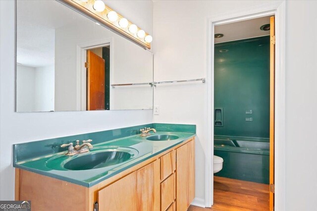 863 Hickory Bluff Rd, Waverly, GA 31565 - full bath featuring a sink, double vanity, toilet, and wood finished floors