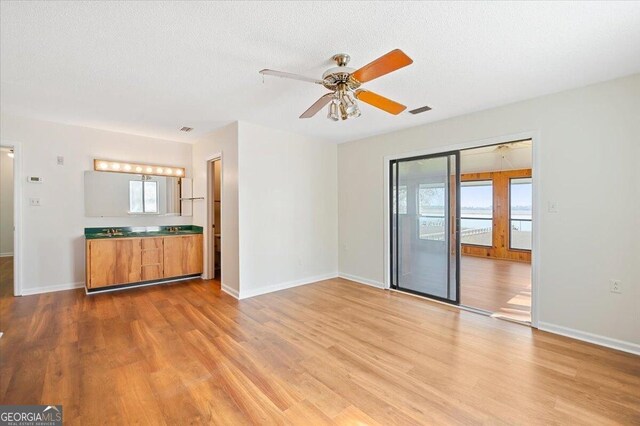 863 Hickory Bluff Rd, Waverly, GA 31565 - unfurnished living room featuring baseboards, wood finished floors, and a ceiling fan