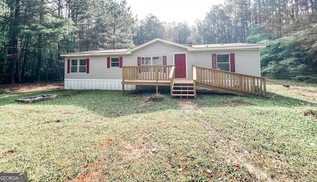 view of front of house featuring a front lawn and a deck