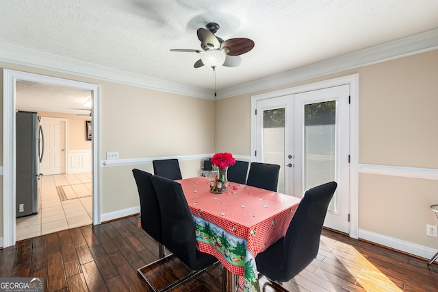 dining space with dark wood-style floors, crown molding, french doors, and a ceiling fan