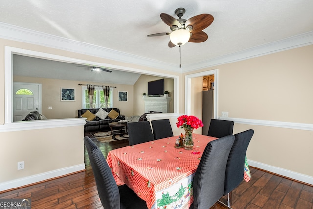 dining room featuring ornamental molding, hardwood / wood-style flooring, baseboards, and a ceiling fan