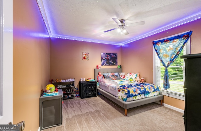 bedroom featuring a textured ceiling, a ceiling fan, and carpet floors