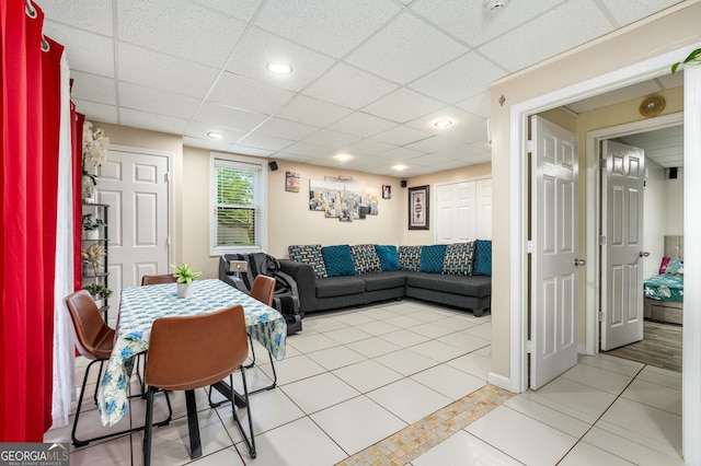 living room with light tile patterned floors, a paneled ceiling, and recessed lighting