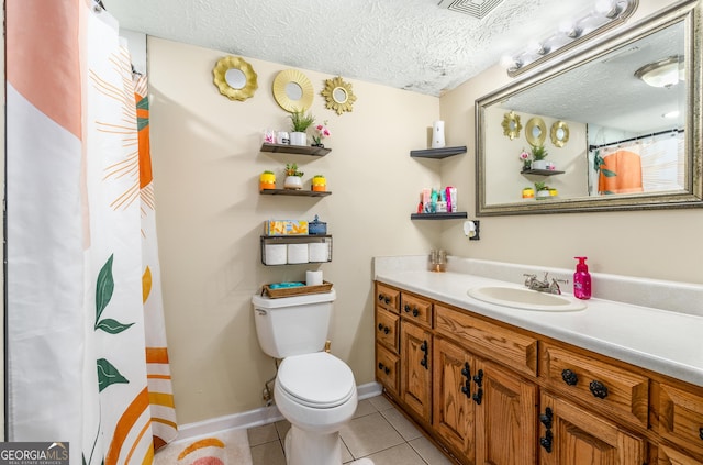 full bath featuring toilet, tile patterned flooring, vanity, and a textured ceiling