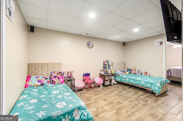 bedroom featuring a paneled ceiling, recessed lighting, visible vents, and wood finished floors