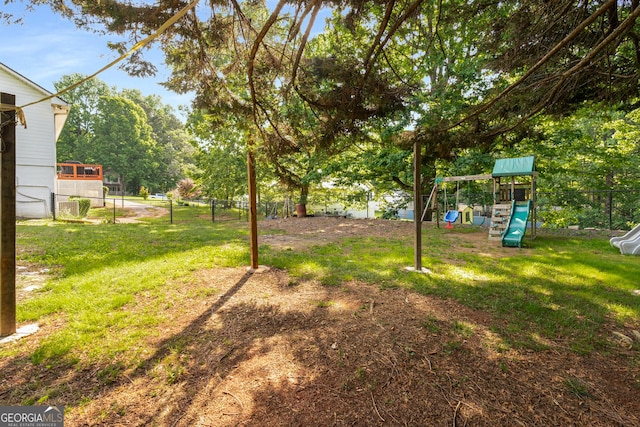 view of yard featuring a playground and fence
