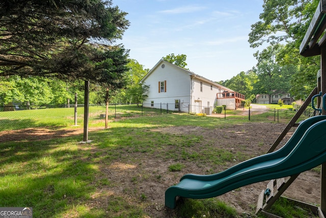 view of yard featuring a playground and fence