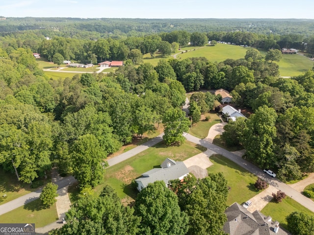 drone / aerial view with a wooded view