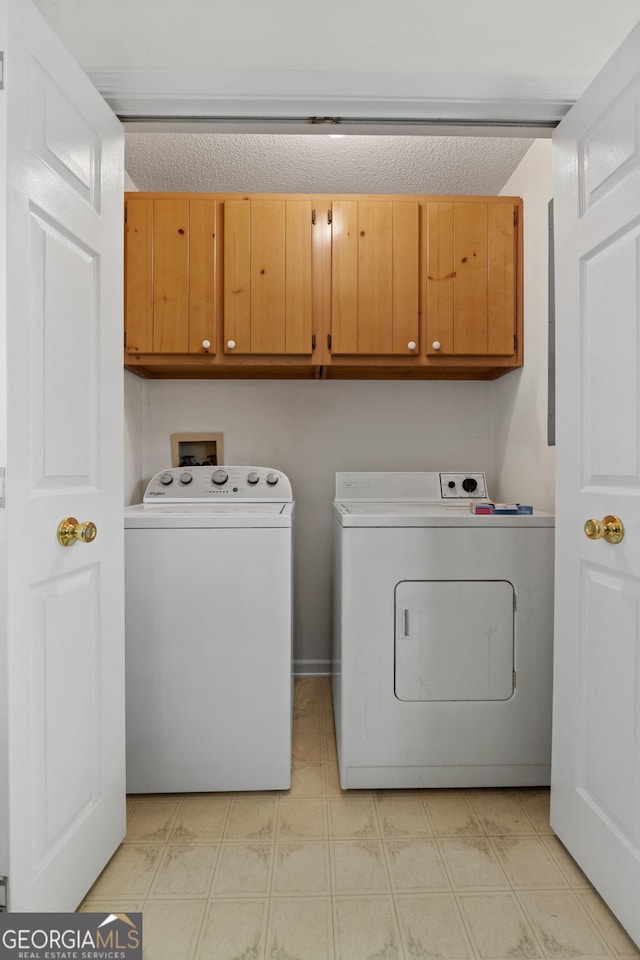 873 Austin Rd, Newnan, GA 30263 - laundry room featuring cabinet space, washer and clothes dryer, light flooring, and a textured ceiling